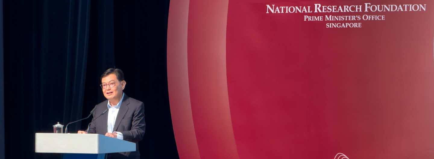 Man at podium with National Research Foundation backdrop; Prime Minister's Office Singapore.
